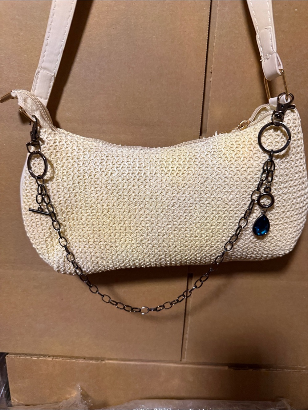 Cream Woven Shoulder Bag with Chain Charm attached blue jewel. Bag not for sale